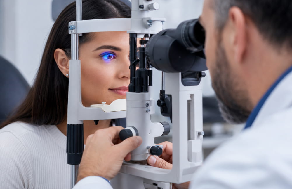 Ophthalmologist performing slit lamp eye examination to assess corneal health before eye color change procedure - Chromatic Eyes
